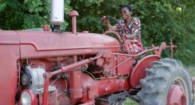 Esther drives a red tractor 