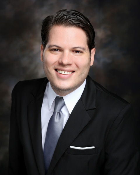 headshot of Alfonso Rojas-Alvarez against dark background