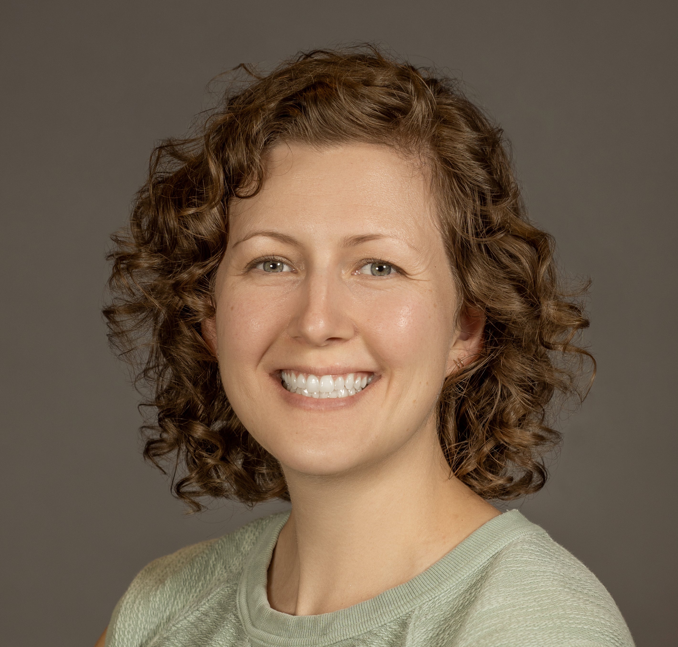 headshot of amy leff against grey background