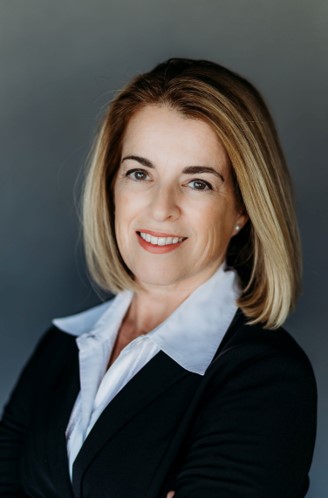 Woman wearing a suit against grey background
