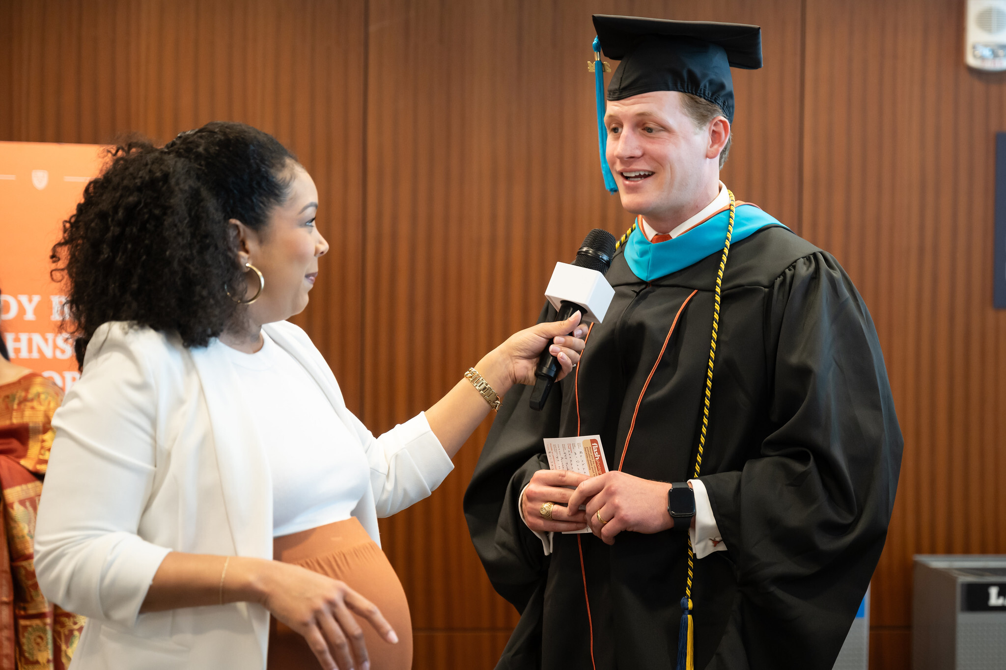 Nathan McDaniel being interviewed during the LBJ School graduation in 2024.