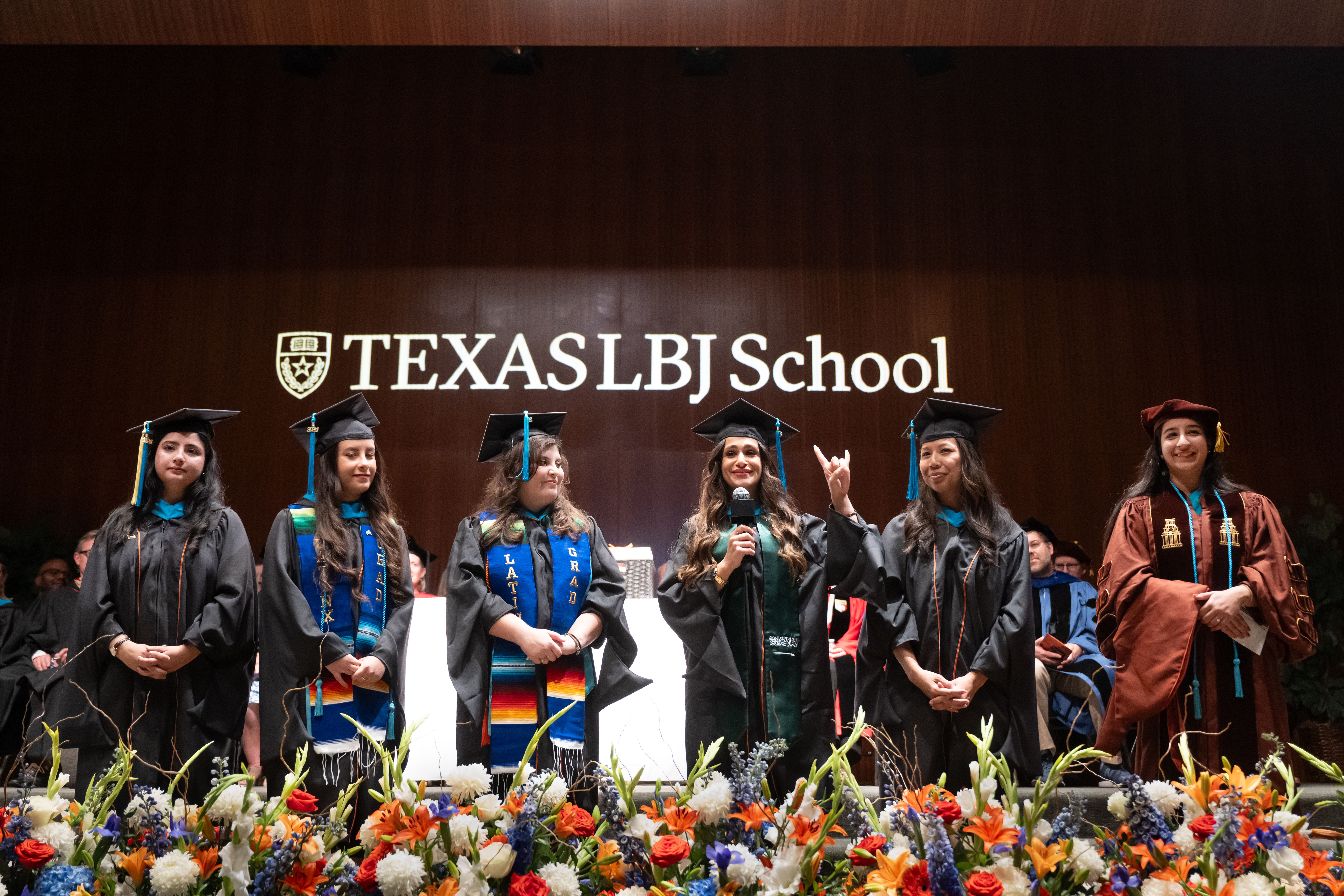 Students provide a greeting in their native languages during a special welcome at the LBJ School 2024 graduation ceremony.