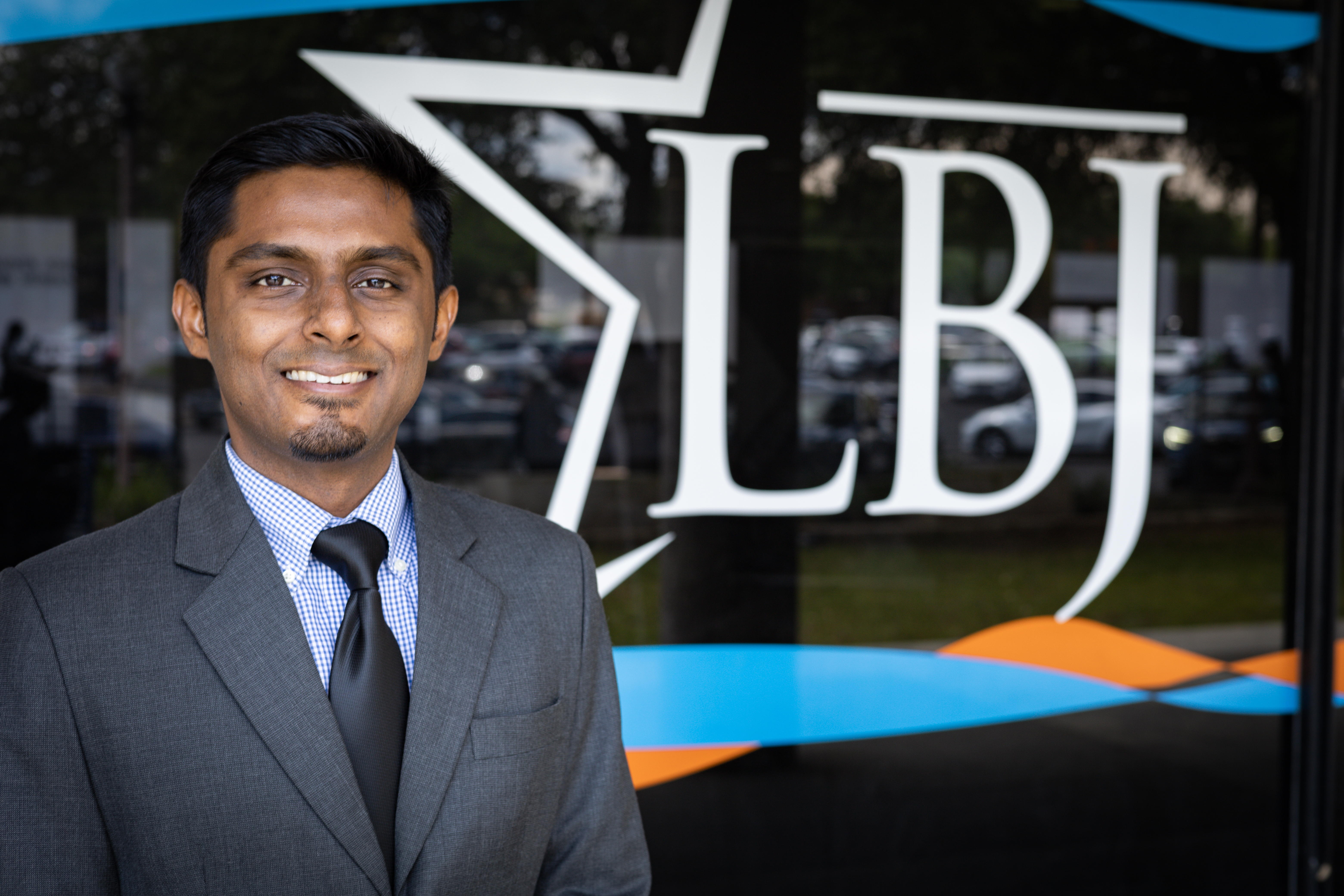 PhD candidate Vivek Shastry posing in front of the LBJ sign.