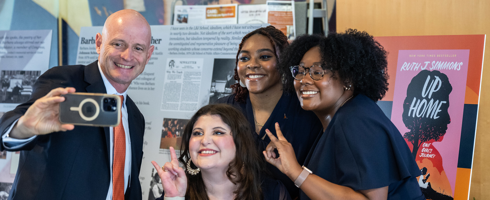 LBJ School dean JR DeShazo posing with students for a selfie.