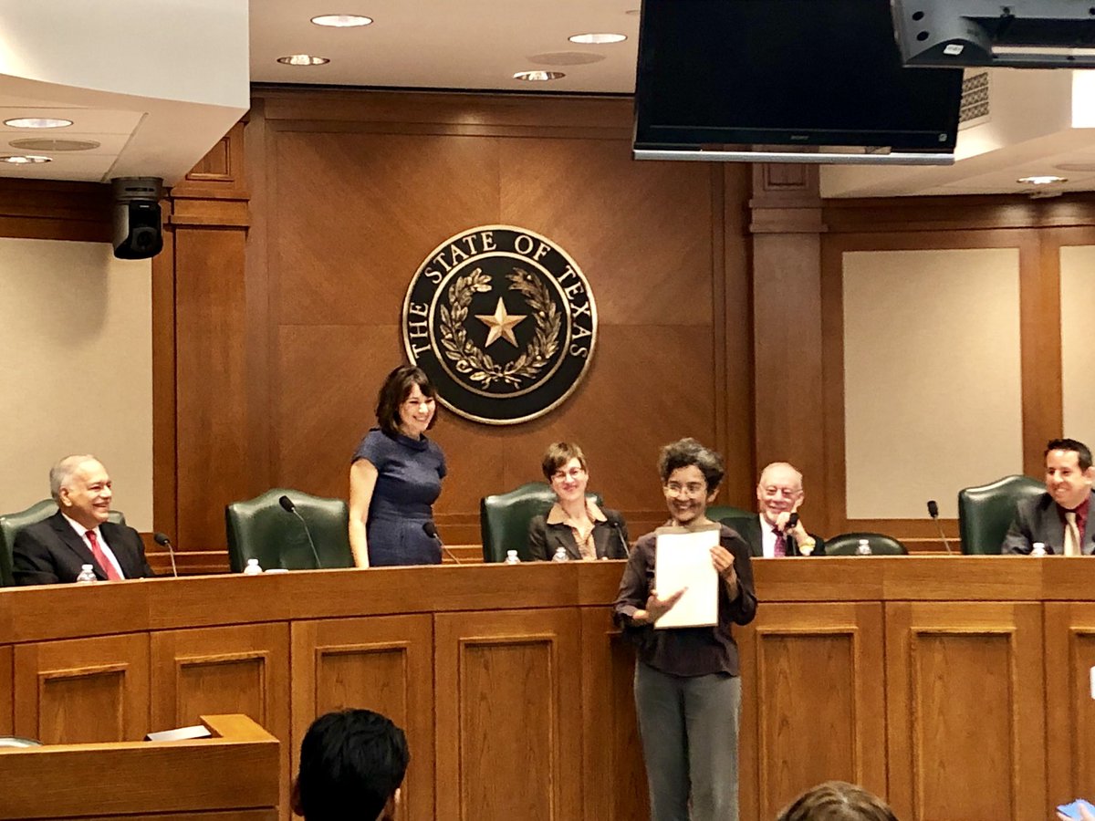 Eva De Luna (MPAff '97) is presented with a resolution honoring her 20 years of state service in Texas