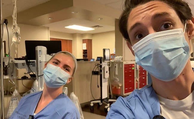 Derreck DaSilva (right) with a colleague on the floor at St. David's Medical Center