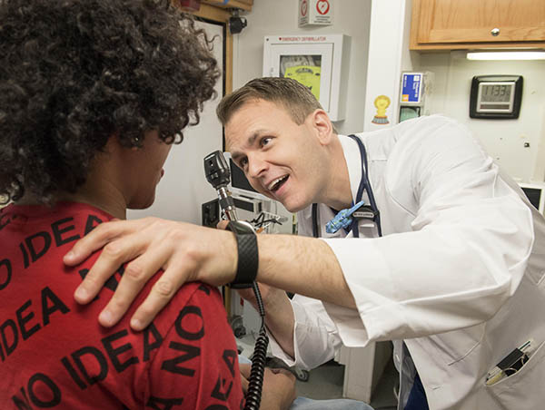 Dr. Michael Hole gives a patient a check-up.