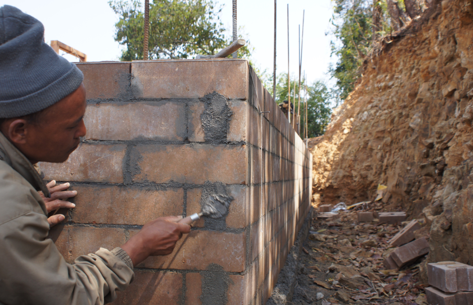 A man rebuilding a house in the Kathmandu Valley of Nepal, where a 7.6 earthquake struck in April 2015