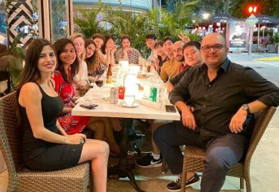 LBJ student Tahar Hichri (right front) at dinner with fellow international students during the 2019 Bollinger Fund trip in Miami.