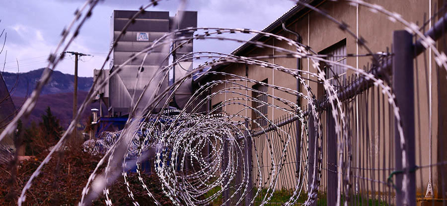Barbed wire on top of a prison fence. Credit: Hedi Benyounes, Unsplash