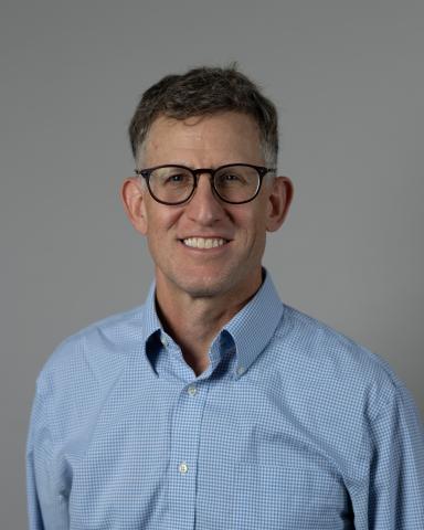 Headshot of Josh Busby against grey background