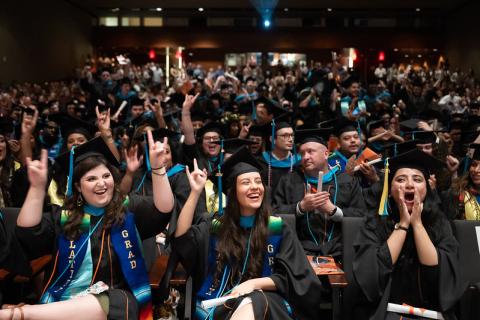 LBJ Graduates in caps and gowns celebrate graduation day 