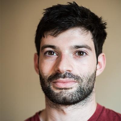 Peter Schwartzstein, a man with dark brown hair wearing a red shirt