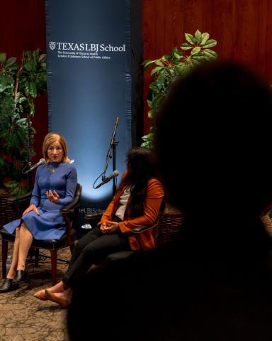 photo of woman at a microphone answering an audience member question