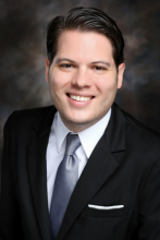 headshot of Alfonso Rojas-Alvarez against dark background