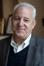 Headshot of BIll Fulton against bookshelf