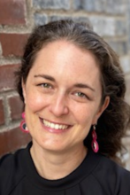 headshot of becky pastner against brick wall