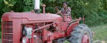 Esther drives a red tractor 