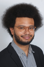 headshot of tye rush against grey background