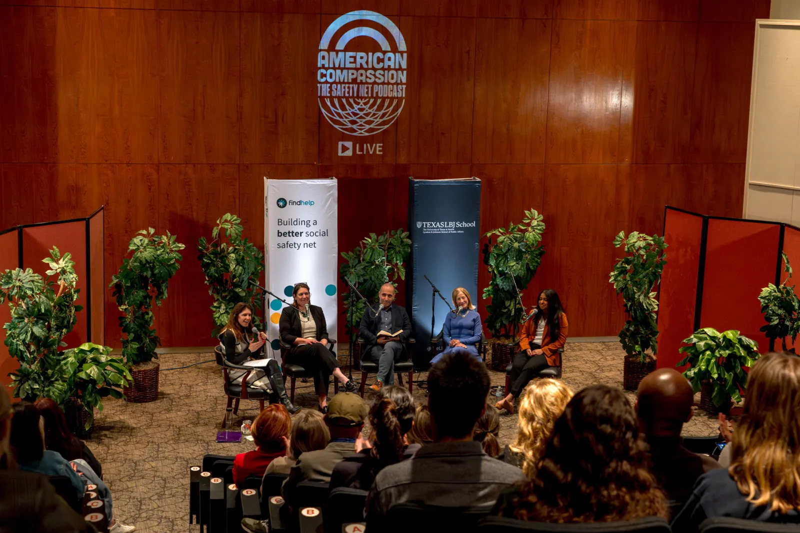 Photo of 3 woman and 2 men speaking into microphones at the LBJ school Bass Lecture Hall