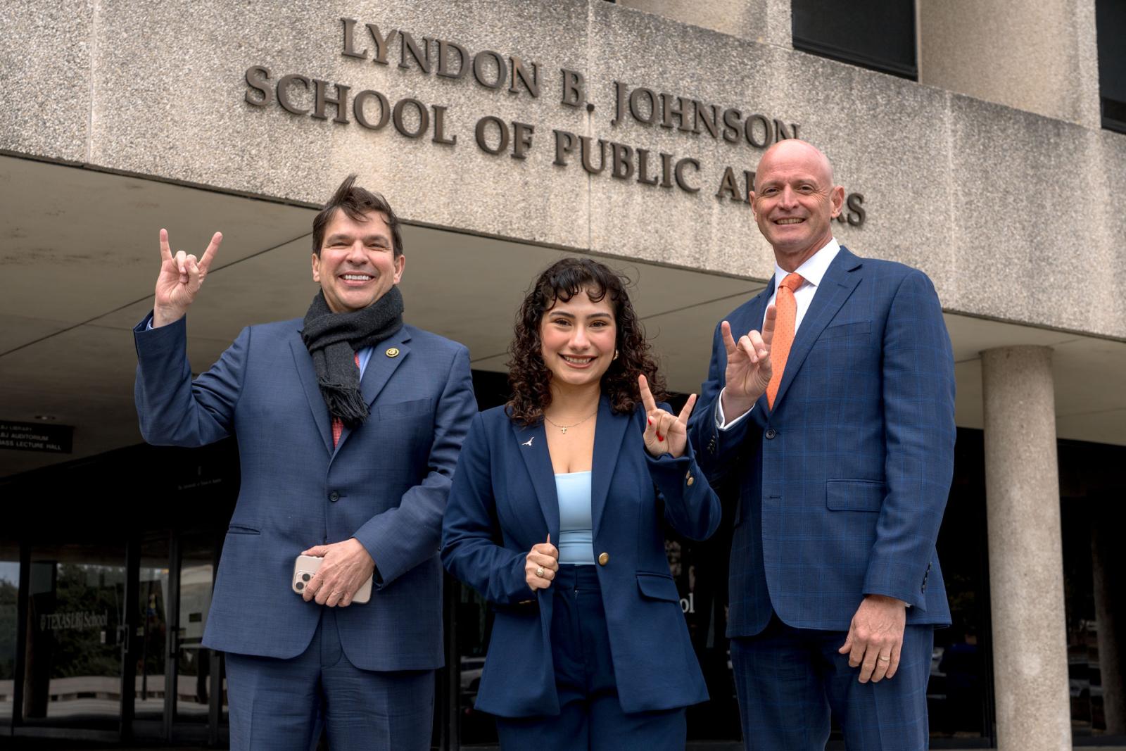BJNF luncheon outside photo Vicente Gonzales, Ashley Alvarado and Dean JR DeShazo standing in front of the LBJ School doing hookem UT hand sign
