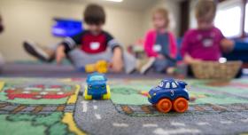 Children play out of focus in a daycare.