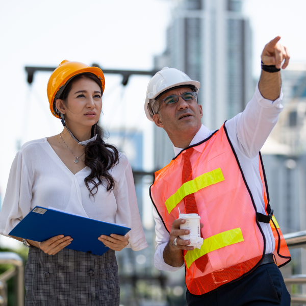 Two engineers pointing in a city