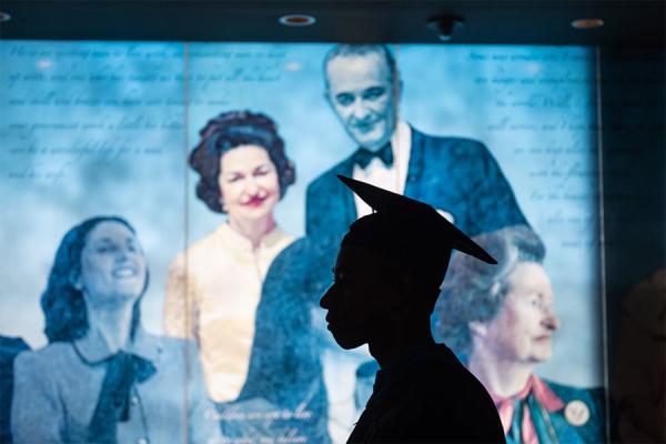 LBJ family mural with graduate