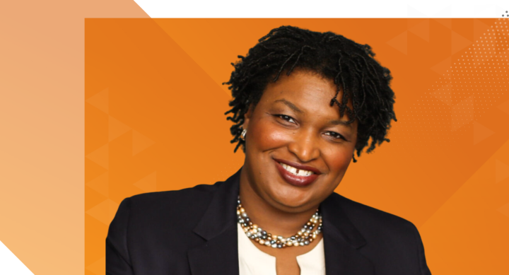 Stacey Abrams against burnt orange background