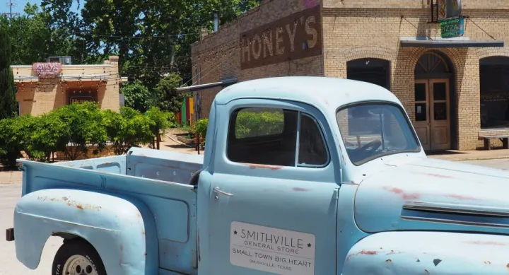 Image of a vintage light blue pickup truck parked in Smithville, Texas