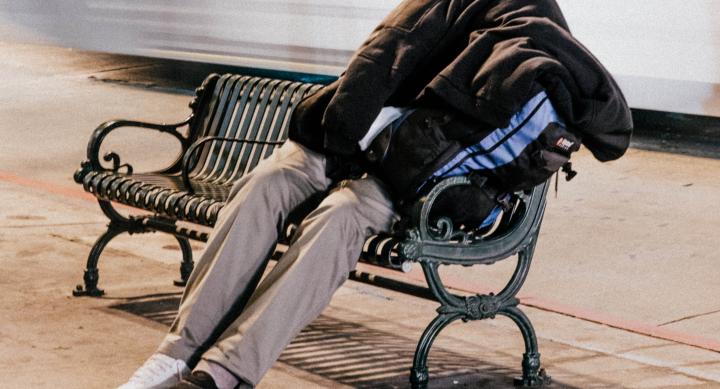 Photo of a homeless man sleeping on a bench — credit: Nathan Dumlao Photo of a homeless man sleeping on a bench — credit: Nathan Dumlao