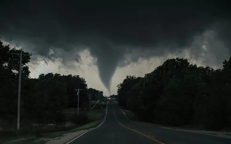 A tornado touches down over a road