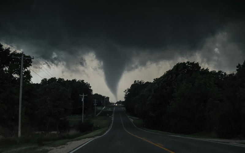 A tornado touches down over a road